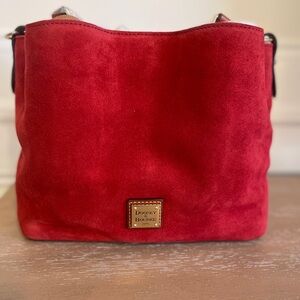 New. Never used. Red suede Dooney and Bourke pocketbook